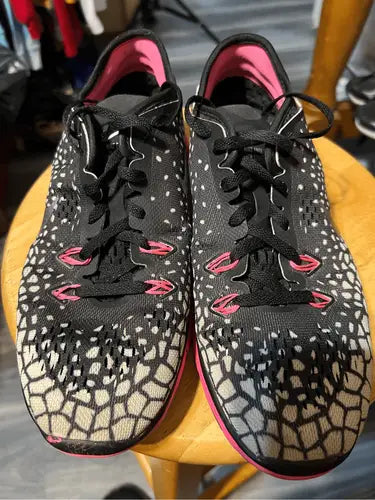 Nike True Fit athletic shoes with black and white polka dots and pink accents