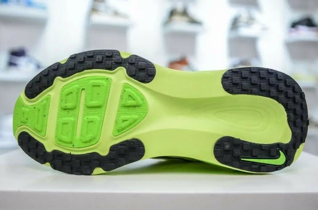 Lime green and black Nike Vomero 18 running shoe sole with swoosh, fast shipping available