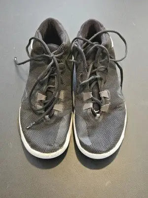 Well-worn Nike Zoom Freak basketball shoes in black mesh with white soles and dark laces