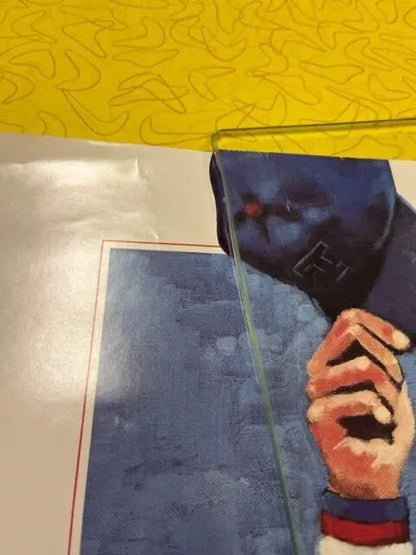 Framed painting of a man in a blue hat, featuring Nolan Ryan HSE memorabilia