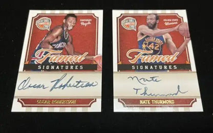Two autographed basketball cards featuring Oscar Robertson and Nate Thurmond Auto from Panini Famed Signatures
