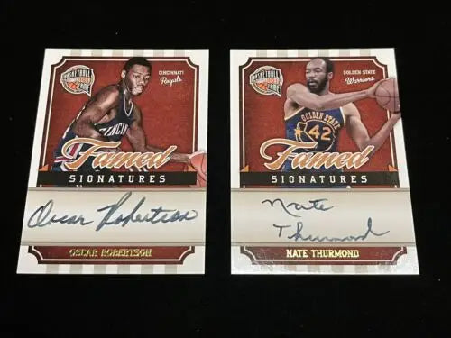 Two autographed basketball cards of Oscar Robertson and Nate Thurmond from Panini Famed Signatures