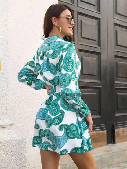 Woman wearing a white green and blue paisley print Johnny collar smocked dress