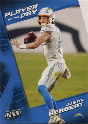 Football player in white uniform ready to throw pass on Panini Base Card Justin Herbert