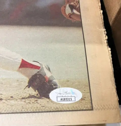 Baseball player sliding into base featured in Pete Rose Auto Sporting News collectible