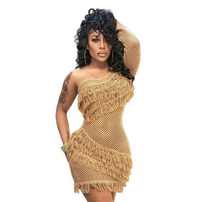 Woman modeling beige crochet dress with fringe and inclined shoulder from Plaid Tassel Skirt collection