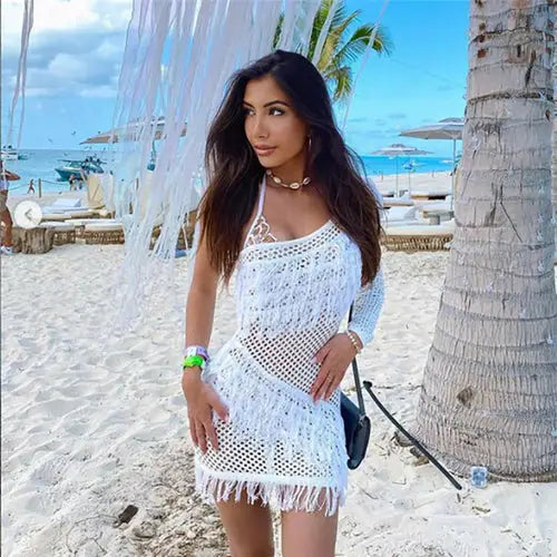 Woman in white inclined shoulder crochet dress, stylish plaid tassel skirt, sexy see-through look