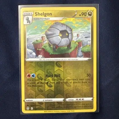 Holographic Shelgon trading card from Pokemon Evolving Skies reverse holo rare M/NM