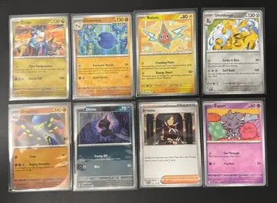 Eight Pokémon TCG Surging Sparks trading cards in protective sleeves for collectors
