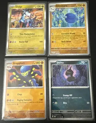 Four Pokémon TCG Surging Sparks trading cards in protective sleeves for collectors