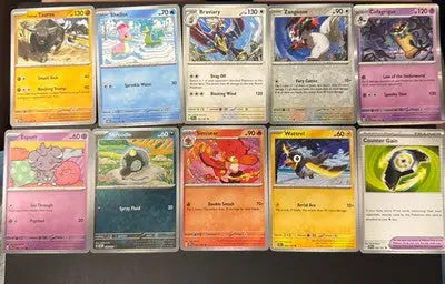 Pokemon Surging Sparks trading cards collection featuring ten cards in a lot of 12