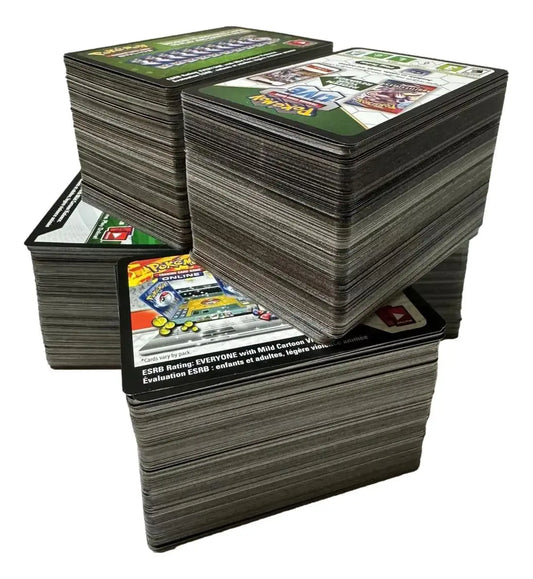 Stacks of trading cards, including Pokemon TCG UNUSED 100 Code Online Cards Lot