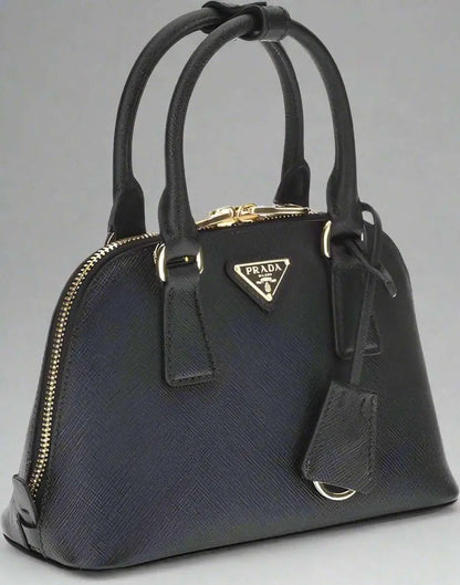 Prada black leather dome handbag with gold hardware for stylish black leather accessory