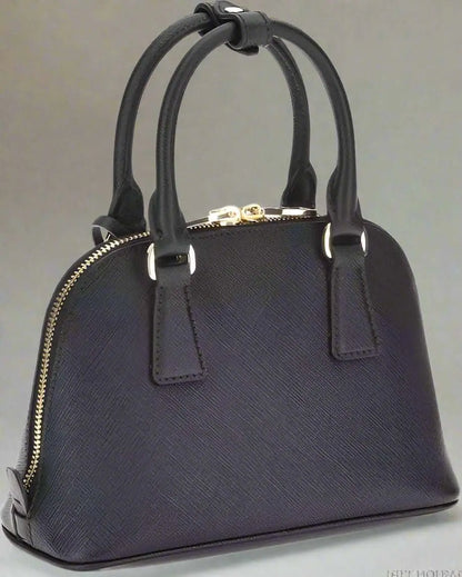 Prada black leather dome satchel with gold-toned hardware on Prada black leather handbag