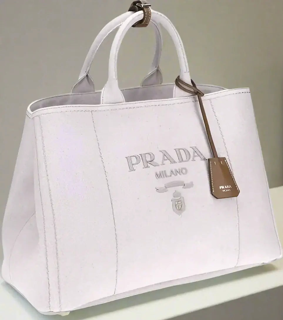 White leather Prada tote bag with top handles and brown leather tag, extra large jardinière style