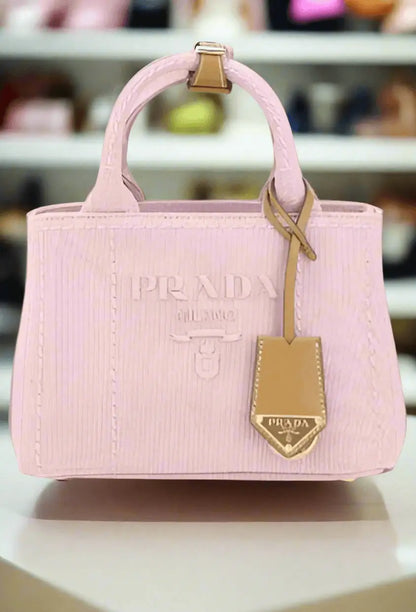 Light pink fabric handbag with embossed stripes and matching hang tag for Prada Pink Fabric Handbag