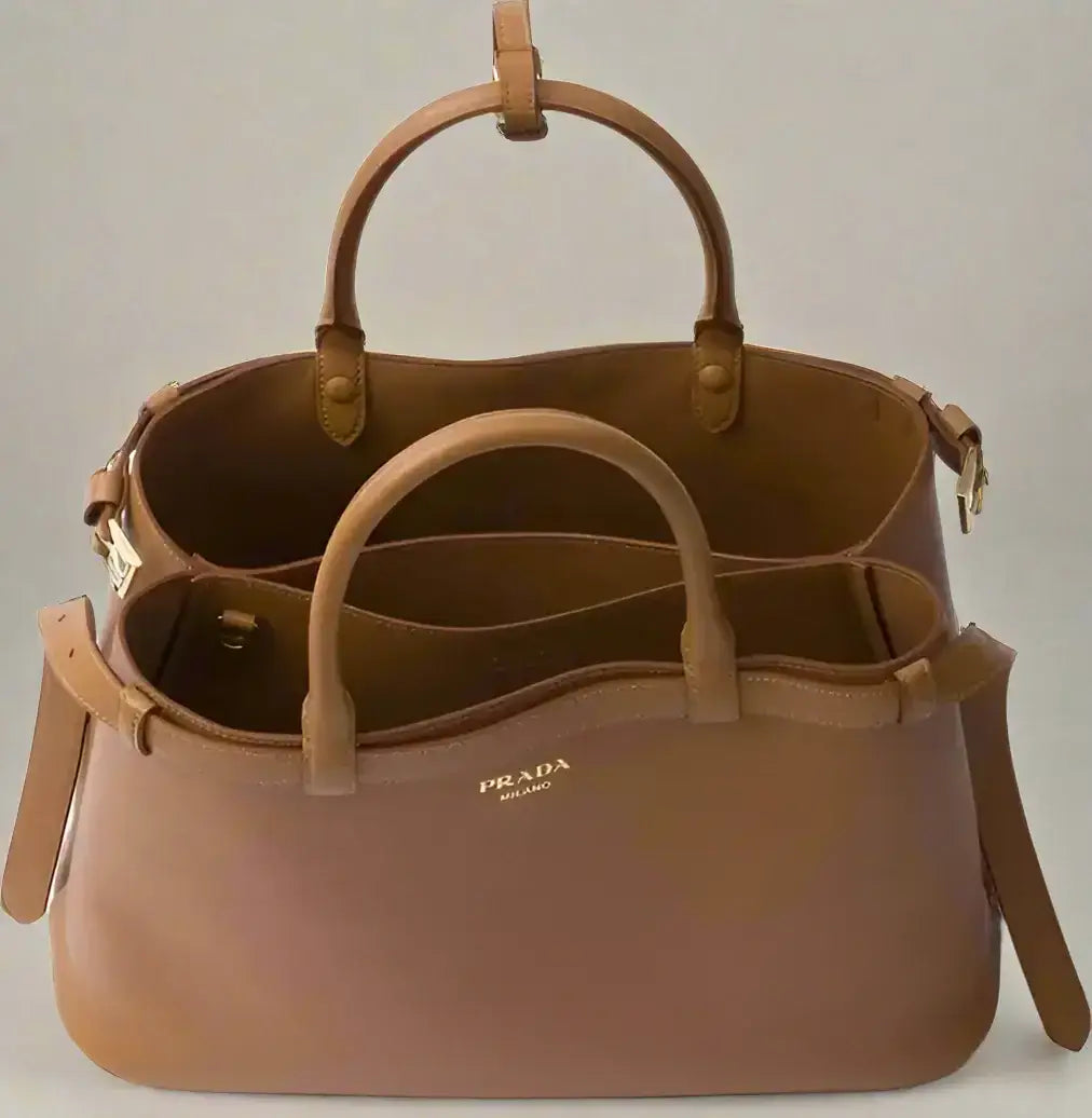 Tan leather Prada handbag with two top handles and open top for women