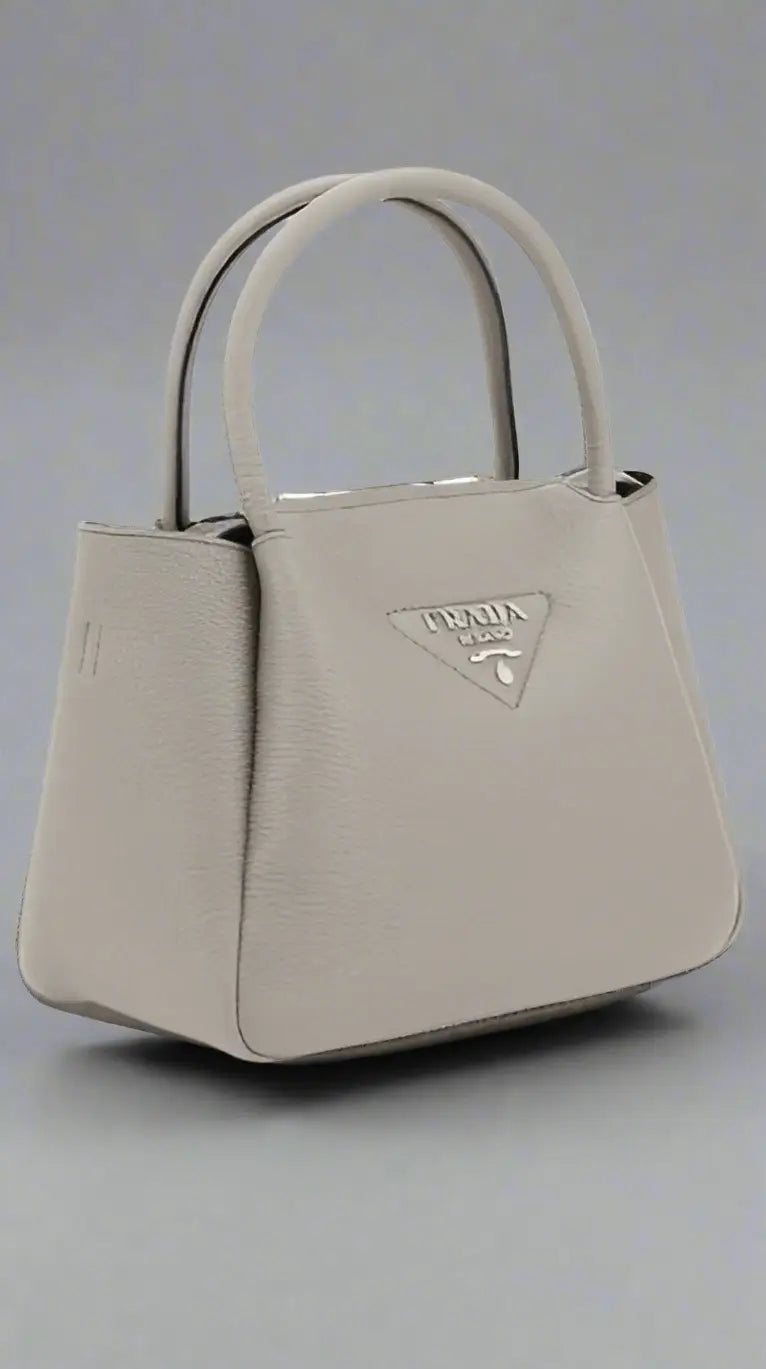 Light gray grained leather tote bag with two top handles at PRADA women’s handbag