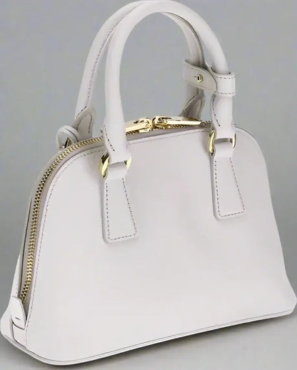 Light grey leather dome satchel with gold hardware, zip closure, and logo patch for PRADA women’s handbag
