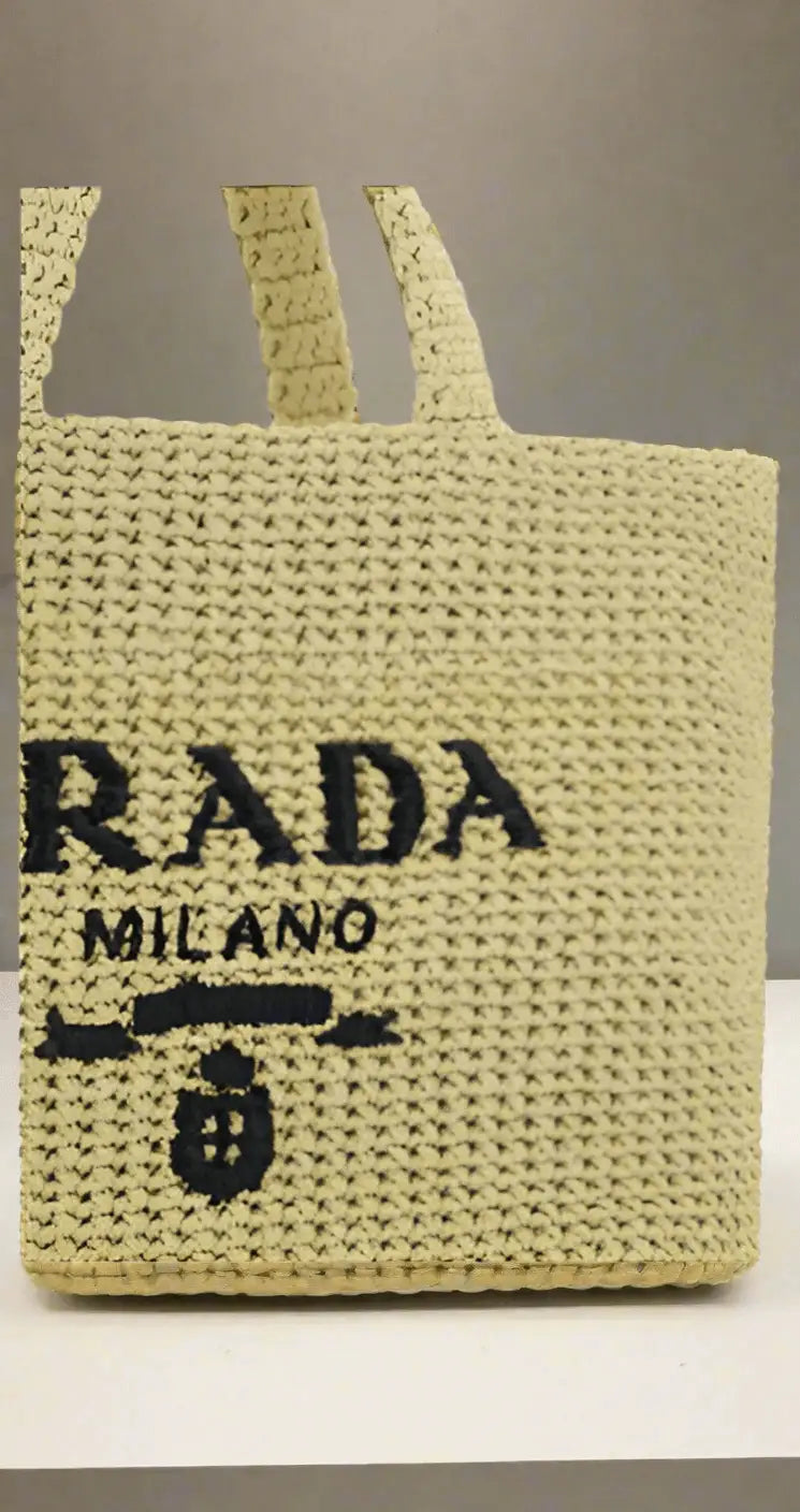 Light yellow Prada woven raffia shopping handbag with black logo for stylish carry