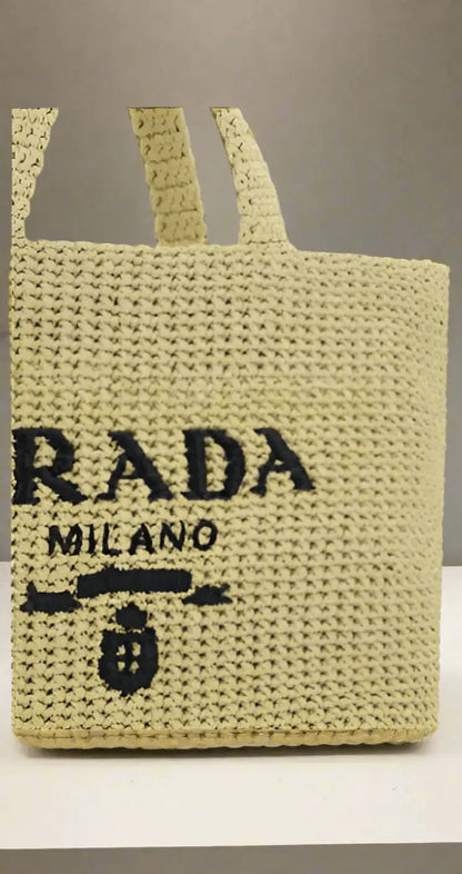 Light yellow Prada woven raffia shopping handbag with black logo for stylish carry