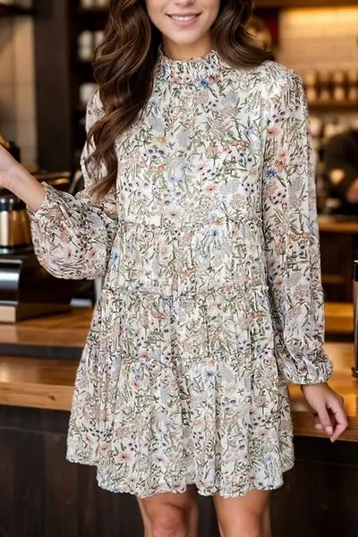 Woman wearing a printed mock neck long sleeve mini dress with floral print