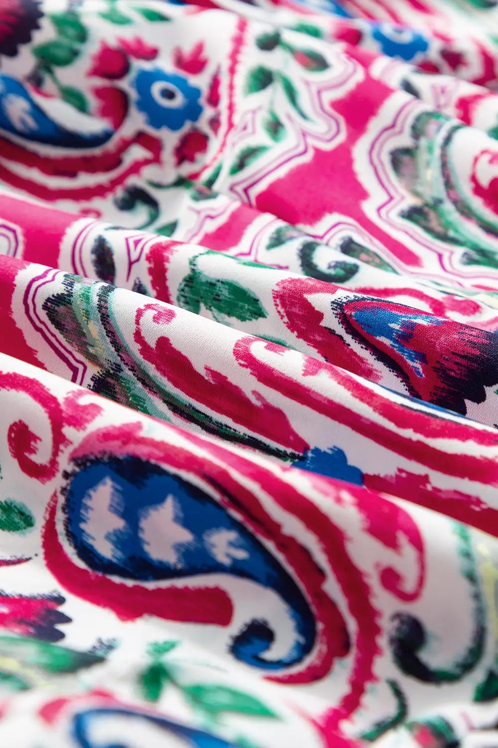 Vibrantly patterned printed tie neck short sleeve dress with paisley and floral motifs