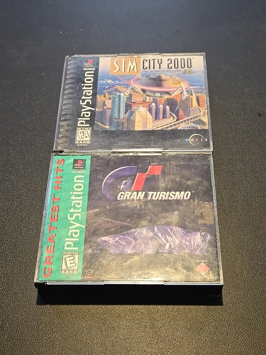 Two used PlayStation games including Sim City 2000 and Gran Turismo Greatest Hits