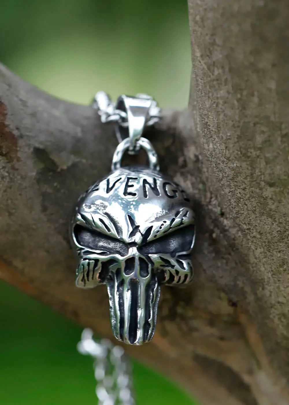 Silver-colored skull pendant with AVENGE engraved, part of the Punisher Revenge Necklace collection