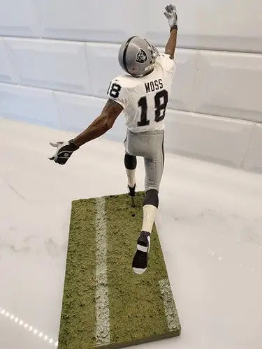 Randy Moss Rare McFarlane action figure in Raiders uniform displayed prominently