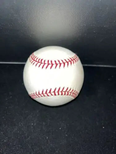 White baseball with red stitching from Rawlings OMLB 2001 Month of the Americas Baseball