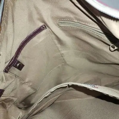 Interior of a beige fabric handbag with multiple pockets, part of the Relic Brown Faux Leather Handbag collection