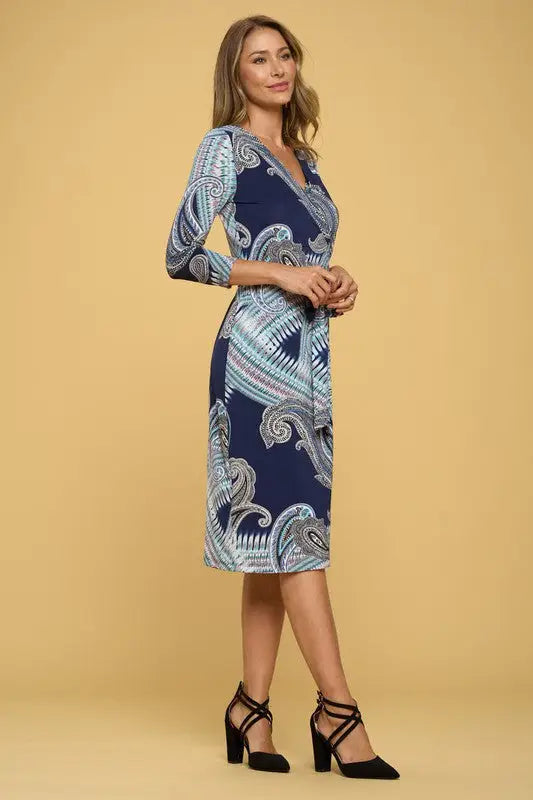 Navy blue jersey wrap dress with paisley pattern and black multi-strap heels