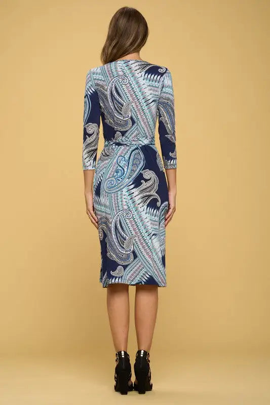 Woman wearing navy blue jersey wrap dress with paisley pattern, perfect for casual wear