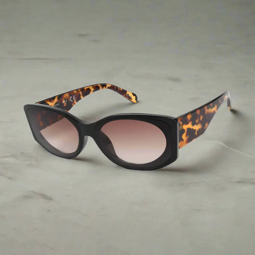 Retro sunglasses featuring black cat-eye frames, brown gradient lenses, and tortoise shell arms for affordable luxury style