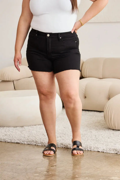 Black denim shorts with high waist, tummy control, button closure, and belt loops