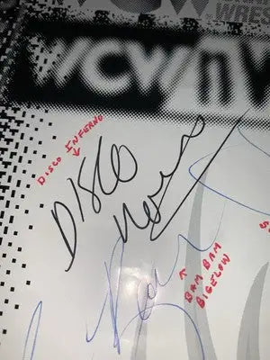 Signed wrestling poster featuring Ric Flair and Arn Anderson on a WWE NWO WCW flyer