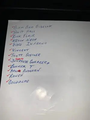 Handwritten list of wrestling personalities on signed flyer featuring Ric Flair and Arn Anderson