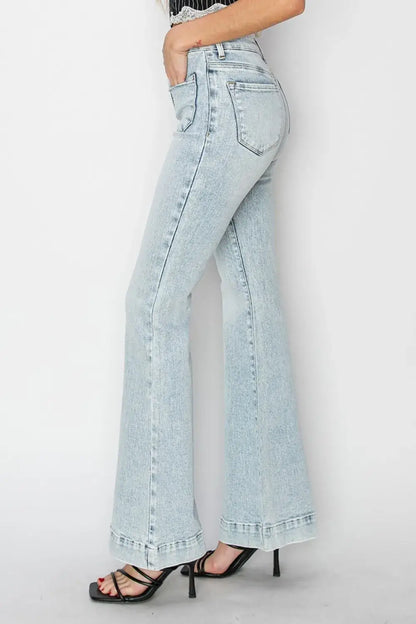 Light wash high-rise patch pocket flare jeans with frayed hems and black strappy heels
