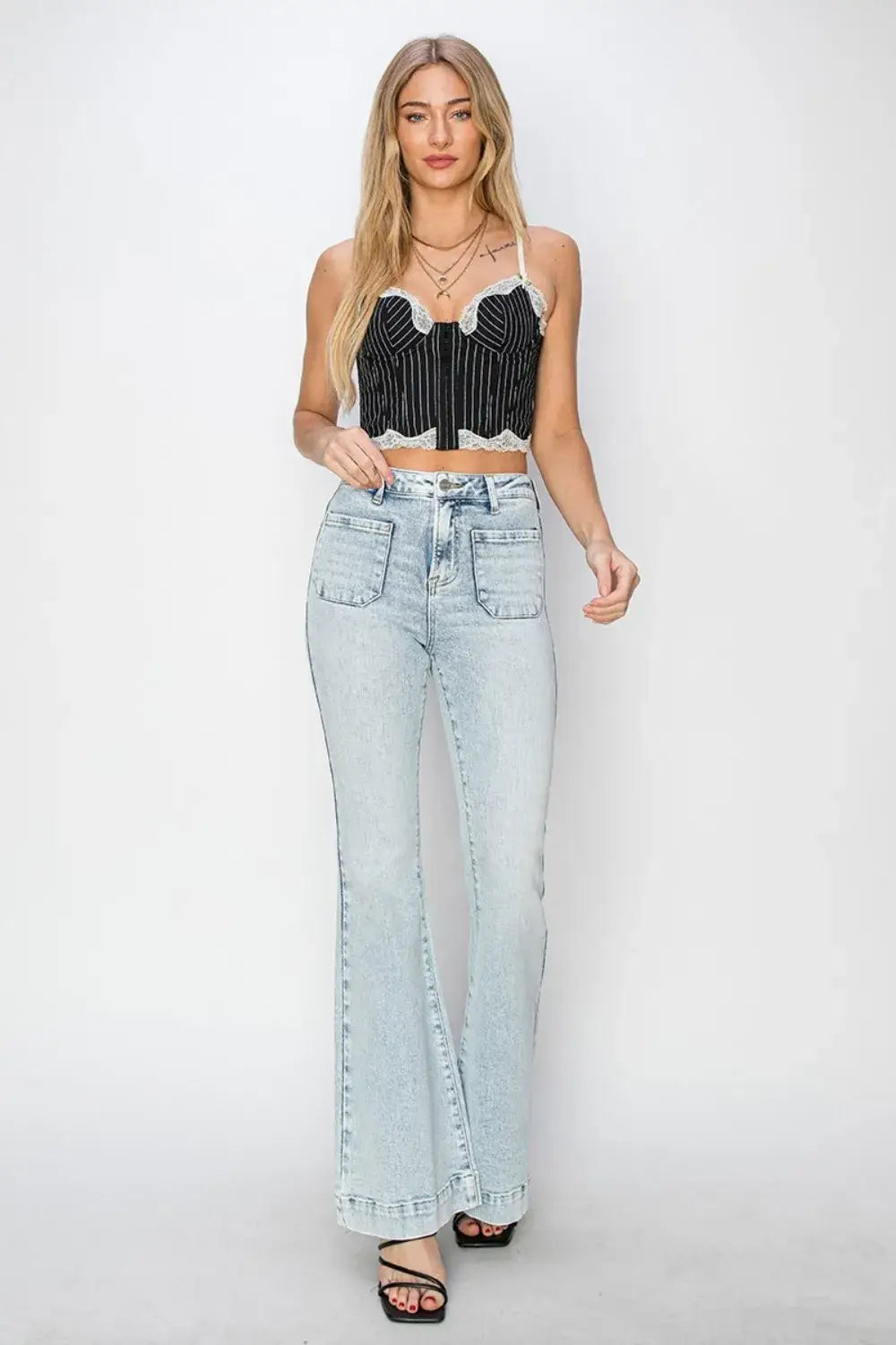 Light wash high rise flare jeans with large front patch pockets and pocket flare design