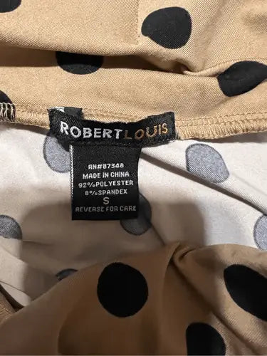 Beige and black polka dot fabric with clothing tag for Robert Louis Skirt