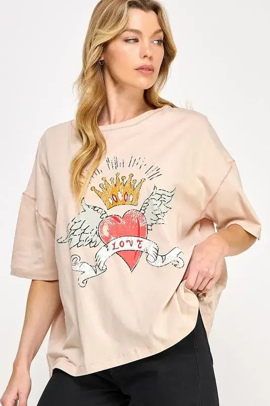 Beige love-inspired graphic oversized T-shirt with heart and crown design, paired with black leggings