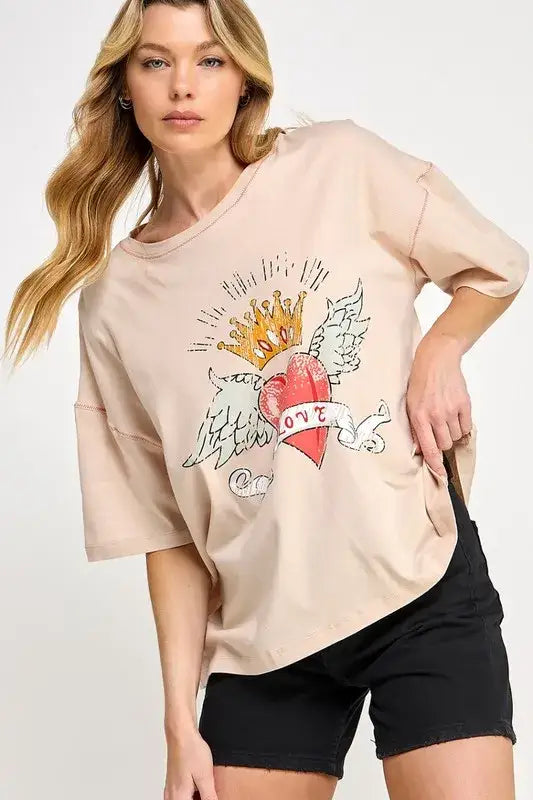 Beige love-inspired graphic oversized T-shirt with heart and crown design, black shorts