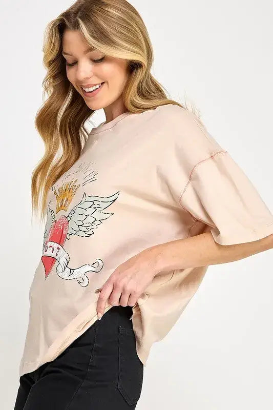 Peach heart wing graphic sweatshirt with black leggings, love-inspired graphic oversized style