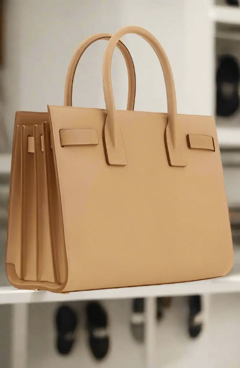 Saint Laurent brown leather handbag with two top handles for versatile style