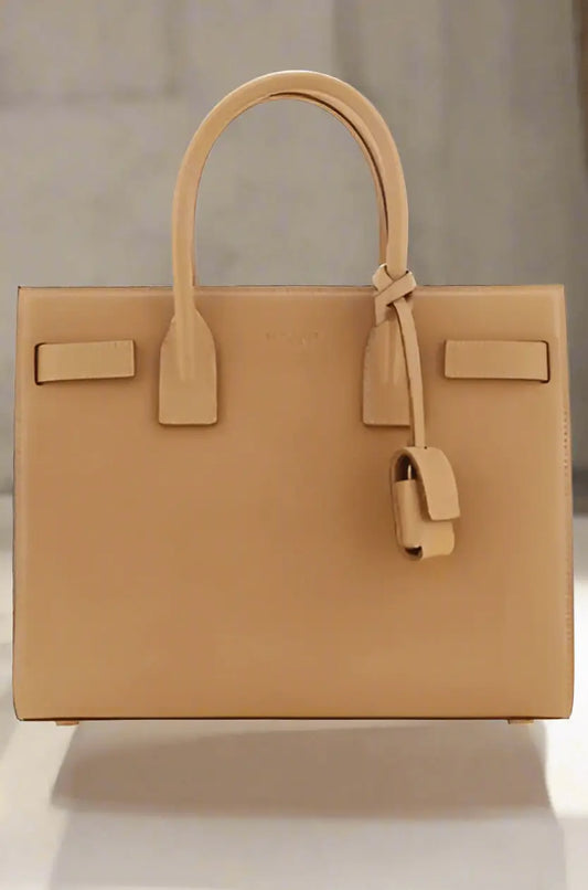 Saint Laurent brown leather handbag with top handles and dangling clochette