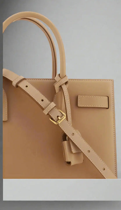 Saint Laurent brown leather handbag with top handle and adjustable shoulder strap