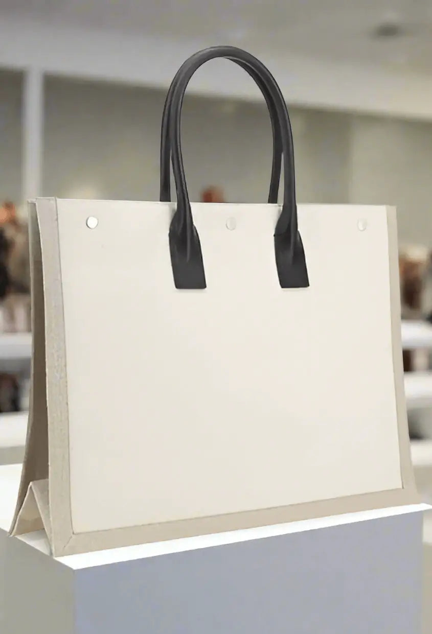 Cream-colored tote bag with black handles from Saint Laurent RIVE GAUCHE collection