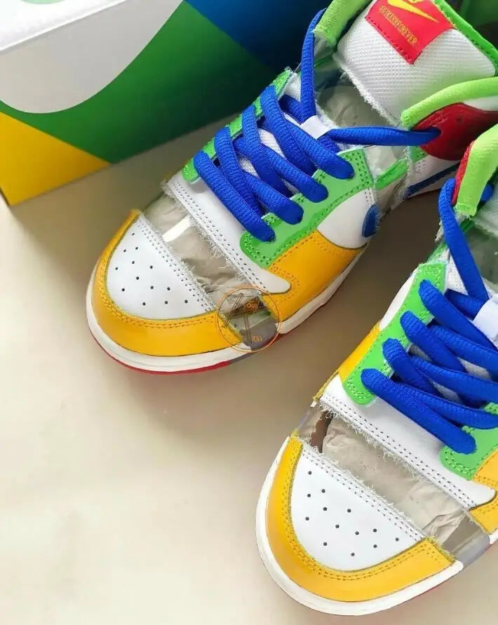 Colorful multi-paneled Sb Dunk Low Sandy Bodecker sneakers with blue laces, fast shipping