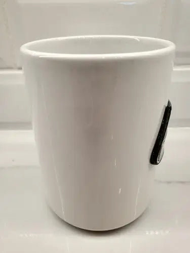 White ceramic coffee mug featuring Seattle Seahawks NFL football raised logo